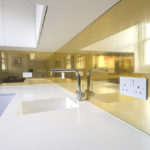 A Picture of A Kitchen with Golden Splashback